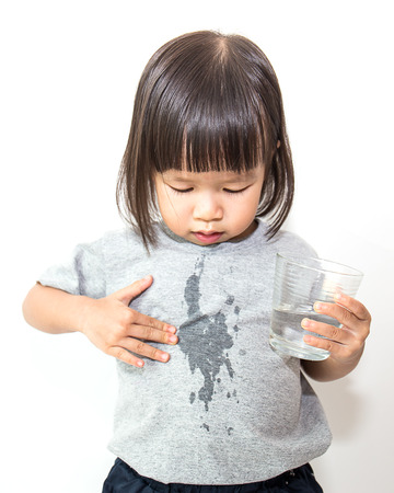 Portrait of young little girl drinking a glass of water. (water, drink, asian)の写真素材