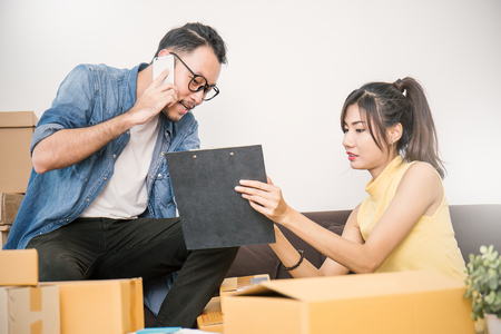 Start up small business entrepreneur or freelance woman and man working at home concept, Young Asian small business owner at home office, on line marketing packaging and deliveryの写真素材