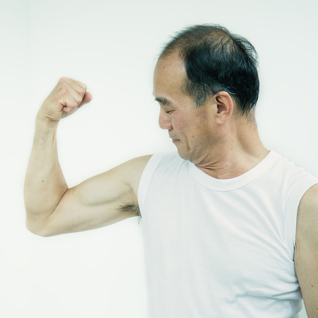 Fitness shaped muscle sport asian man posing, Senior muscular asian male body, stay in shapeの写真素材