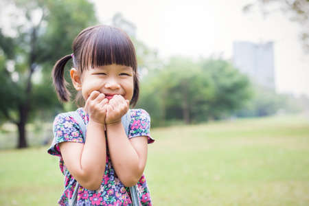 Fun in the park. Portrait of little asian girl having a good happy time in the park. Education green environment spring and summer time conceptの写真素材