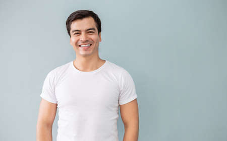 Attractive handsome smiling positive caucasian happy business man. Closeup portrait caucasian polite middle age man wearing white t-shirt. People lifestyle conceptの写真素材