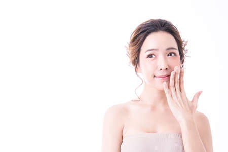 Portrait of attractive asian woman skin care image isolated on white background, Closeup asian beautiful girl with her hand touching her chin looking up.の写真素材