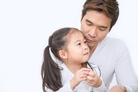 Portrait of beautiful asian father and daughter isolated on white background. Single dad family closeup man with little girl, love and together concept.の写真素材