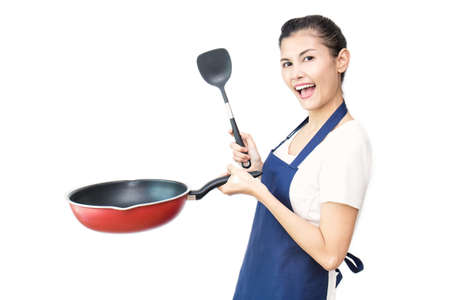Portrait of Cheerful Asian Woman Having Fun While Cooking with pan Isolated On White. Happy housewife holding pan, housekeeper maid service conceptの写真素材