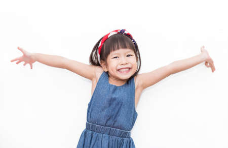 Closeup portrait of little asian girl wearing head band American Flag isolated on white background....