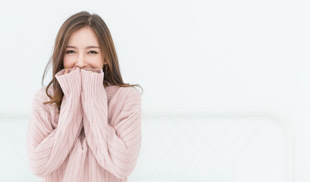 Portrait of young beautiful innocence asian woman relax in her bedroom. Smile happy face asian girl wear winter cloth. Beauty treatment perfect clear skin japanese makeup  lifestyle concept banner backgroundの写真素材