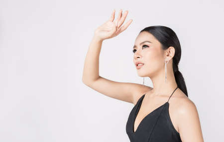 Closeup portrait young beauty sexy asian fashion girl with with hand up protect sun light. Beautiful...