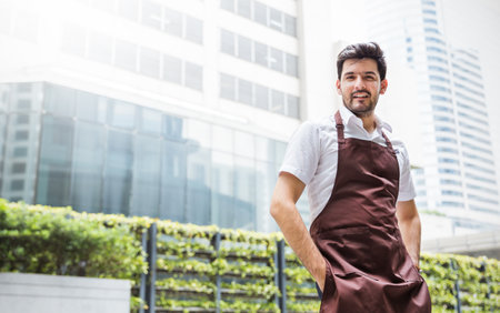 Startup successful small business entrepreneur owner man stand in his coffee shop or restaurant. Portrait of young caucasian man successful barista cafe ownerの写真素材