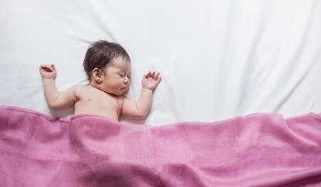 Closeup portrait of asian baby sleeping over white bed cover pink blanket with copy space, Family love newborn hospital healthcare daycare nursery concept panoramic bannerの写真素材