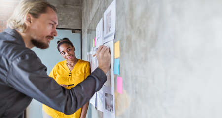 Portrait of business people meeting at office and use sticky notes to share ideas. Brainstorming...