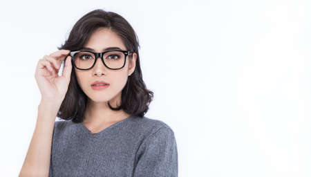 Attractive beautiful smiling positive asian happy nerd woman. Closeup portrait asian nerd girl wearing t-shirt isolated on white background. Success happy emotion expression successful conceptの写真素材