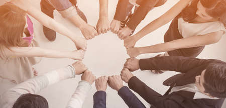 Multicultural hands synergy brainstorm business man woman in circle top view over white vintage background. Support helping teamwork together international diversity race ethnicity harmony education and people concept panoramic bannerの写真素材
