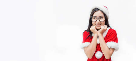 Portrait of little cute asian nerd girl wearing red santa hat, christmas concept, little asian teenage celebrate xmas with her big smile panoramic bannerの写真素材