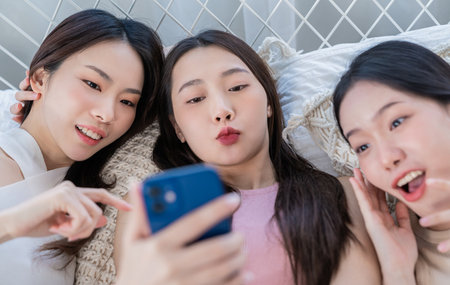 Portrait of international multiethnic student faces posing for selfie shot, group of attractive woman at home living room. Gather cheerful smart cosmetic Youtube blogger, party fun together conceptの写真素材