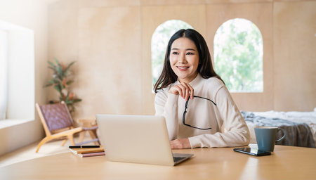 Portrait of nerd sme business asian woman work from home at online computer desktop table. Beauty Asia freelancer girl using laptop in bed room. Small business sme digital network, technology.の写真素材