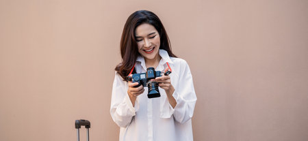 Portrait young beautiful asian woman traveler stand hold suitcase full body on holiday vacation summer time. Happy cheerful asian girl solo travel in summer. Korean University woman fashion lifestyle.の写真素材