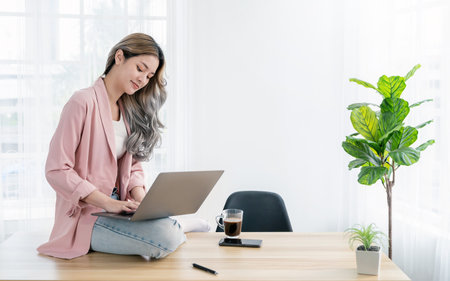 Portrait beautiful business asian creative pink suit woman online work office desk use computer copyspace Success business people employee freelance sme online marketing work at home, coworking spaceの写真素材