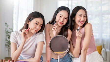 Portrait of young beautiful asian group friends girl in morning makeup routine. Beauty blogger woman, perfect glow skin dress up lipstick. Health care woman, together lifestyle cosmetic bloggerの写真素材
