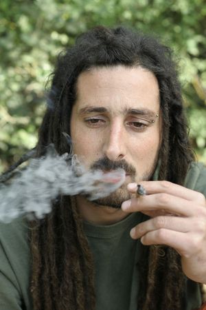 hippy preparing, rolling and smoking marijuana joint : photos seriesの写真素材