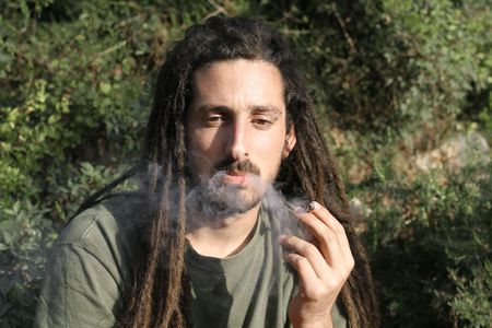 hippy preparing, rolling and smoking marijuana joint : photos seriesの写真素材
