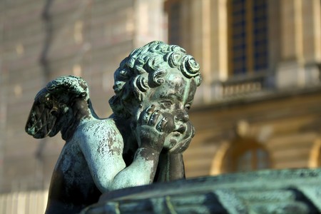 little angel child statue in the gardens of Versailles in Paris, Franceの写真素材