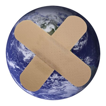 Our world is Plastered!Heal the world - plaster on planet earthの写真素材