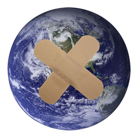 Our world is Plastered!Heal the world - plaster on planet earthの写真素材