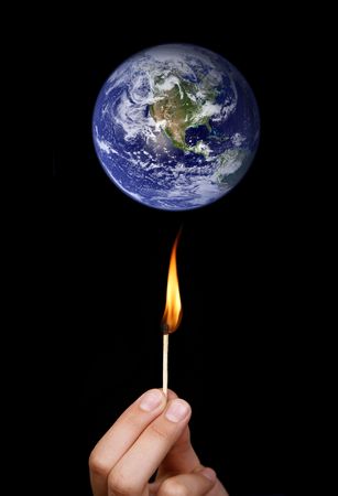 Global warming concept: match stick burning the worldの写真素材