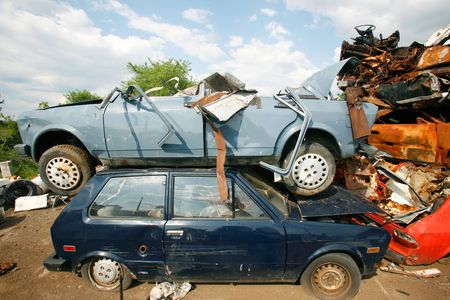 Cars piled on top of each other in junkyardの写真素材