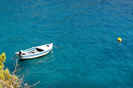 Old wooden fishing boat moored on mediterranean seaの写真素材
