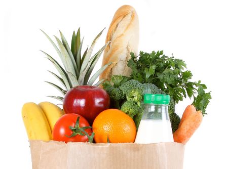 Brown paper shopping bag filled with fresh fruit and vegetablesの写真素材