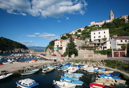 village at the coast with a small harbor vrbnik croatiaの写真素材