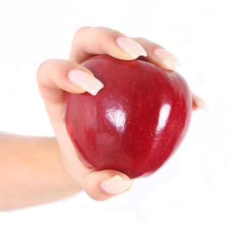 Woman with long nails holding shiny red appleの写真素材