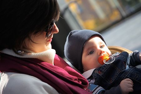 mother taking care of her new born baby during winterの写真素材
