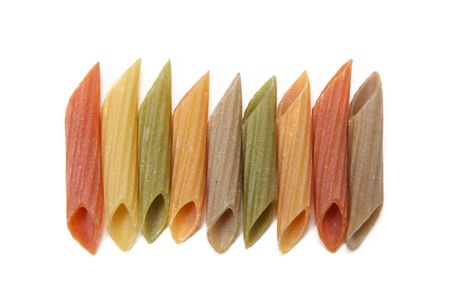 Multi coloured penne row aligned on isolated white backgroundの写真素材