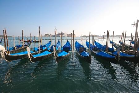 Group of gondolas docked on the water.の写真素材