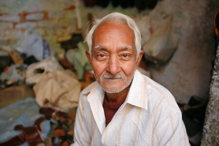 Delhi - January 27: Portrait of elderly man in shoe workshop on January 27th, 2008 in Delhi, India.のeditorial素材
