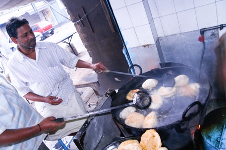 DELHI - OCTOBER 28: Two men preparing Puri in small roadside restaurant on October 28, 2007 in Delhi, India. Chapatis are the staple diet of all Indians.のeditorial素材