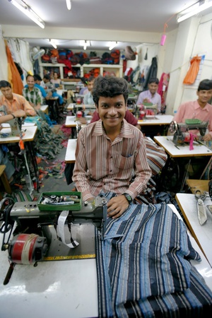 INDIA - FEB 26: Textile workers in a small factory in Old Delh on February 26, 2008 in Delhi, India. Many small factories provide the West with their clothes.のeditorial素材