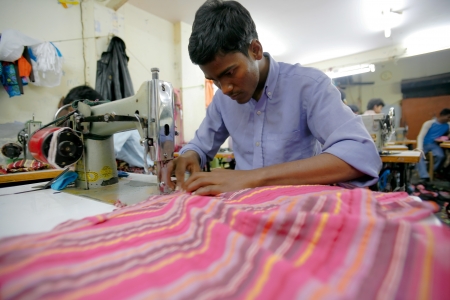 INDIA - FEB 26: Textile workers in a small factory in Old Delh on February 26, 2008 in Delhi, India. Many small factories provide the West with their clothes.のeditorial素材