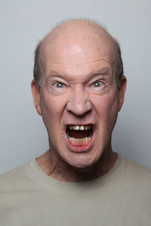 Angry man showing his teethの写真素材