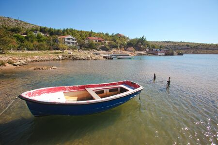 Old moored boat in a lonely bay on the Croatian coastのeditorial素材