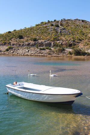 Old moored boat in a lonely bay on the Croatian coastのeditorial素材