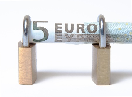 Secured Euro bill rolled into padlock on isolated white backgroundの写真素材