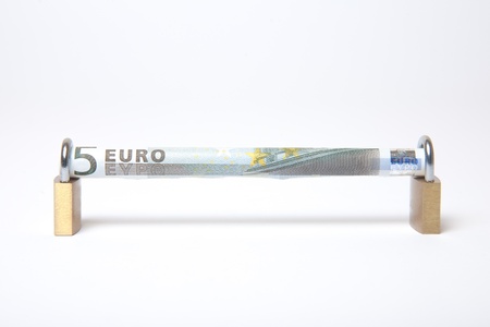 Secured Euro bill rolled into padlock on isolated white backgroundの写真素材