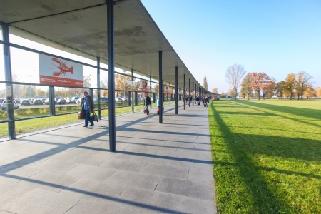 BERLIN, GERMANY - NOVEMBER 2, 2011: Passengers walking to Berlin airport on November 2, 2011 in Berlin, Germany. This passage way from the train station protects passengers from rain and wind.のeditorial素材