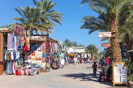 DAHAB, EGYPT - JANUARY 24, 2011: Sellers infront of their stands with clothing on January 24, 2011 in Dahab, Egypt. Dahab has many shops on the street because of the tourists who come there.のeditorial素材