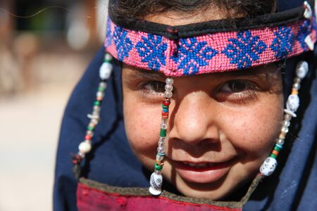 DAHAB, EGYPT - JANUARY 24, 2011: Egyptian girl posing on January 24, 2011 in Dahab, Egypt. She wears a a burqa with traditional ornaments.のeditorial素材