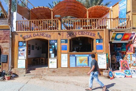 DAHAB, EGYPT - JANUARY 24, 2011: Man walking by the dive center on January 24, 2011 in Dahab, Egypt. Dahab has many diving centers because it is near the Blue Hole.のeditorial素材