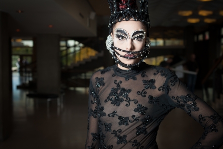Woman in fashion clothes with mask ready for stage performanceの写真素材